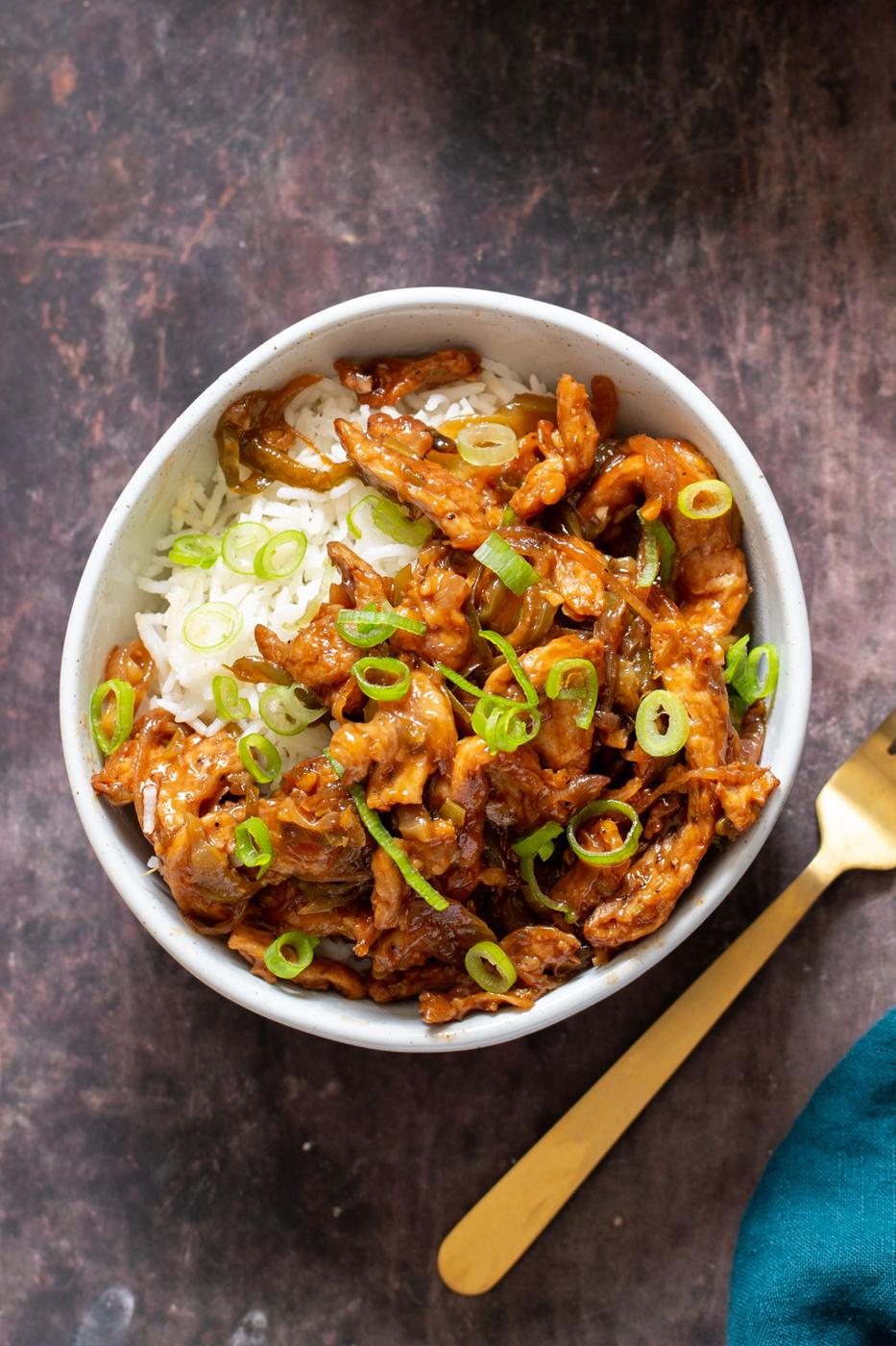a plate of vegan Indo Chinese chilli chicken served over rice