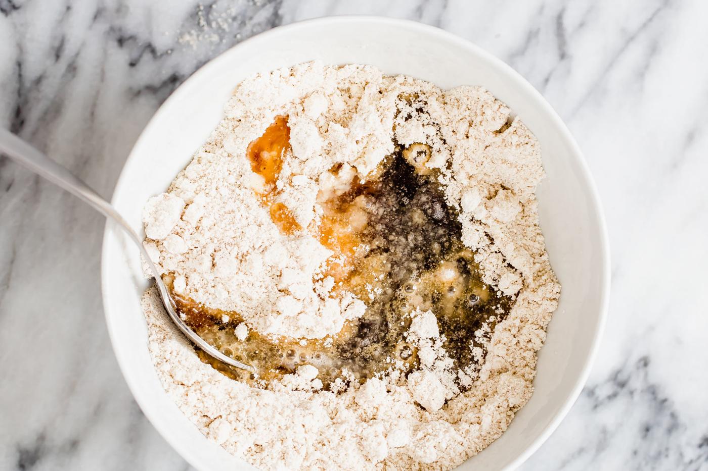 vegan snickerdoodle cookie batter being mixed in a white bowl