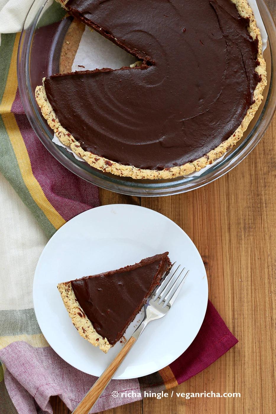 overhead shot of a Vegan Chocolate Pumpkin Pie in a pyrex pie dish with plated slice of pie on the side