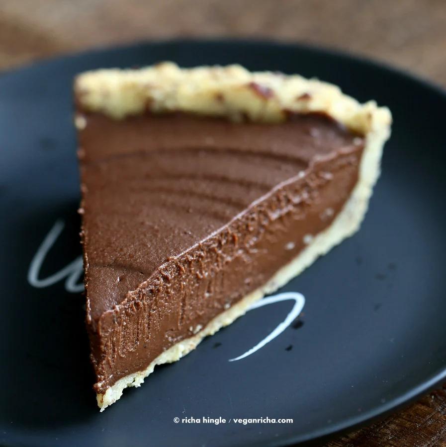 close-up of a slice of Vegan Chocolate Pumpkin Pie with Almond Flour Pie Crust on a black plate