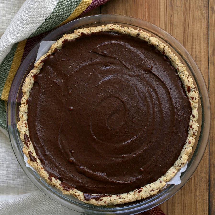 overhead shot of a whole Vegan Chocolate Pumpkin Pie in a pyrex pie dish