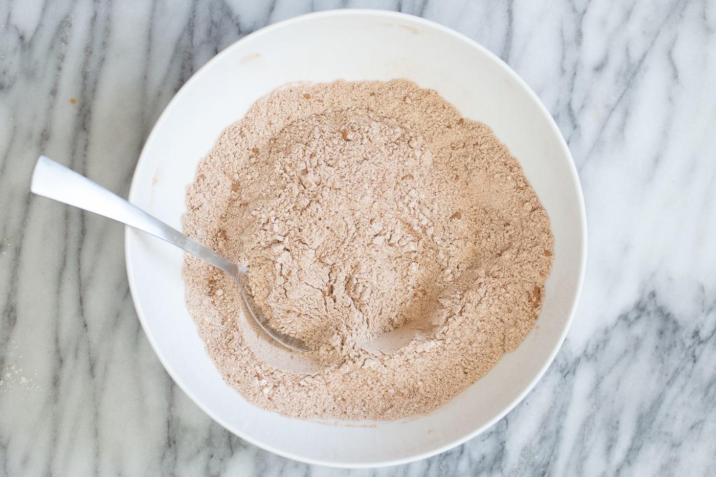 dry ingredients for chocolate zucchini bread in a white bowl