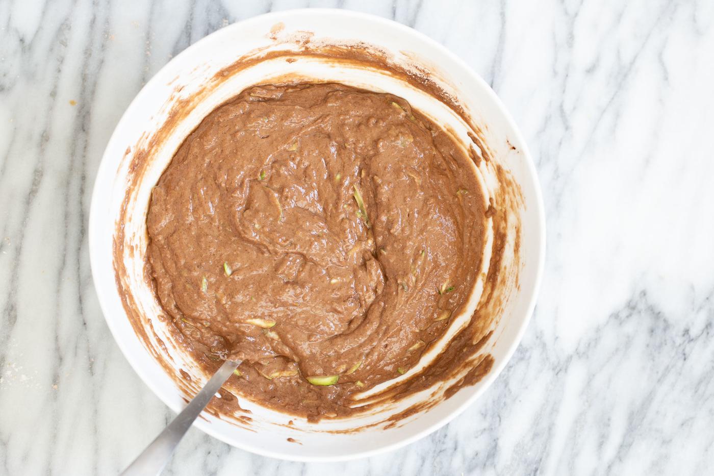 chocolate zucchini cake batter in a white bowl