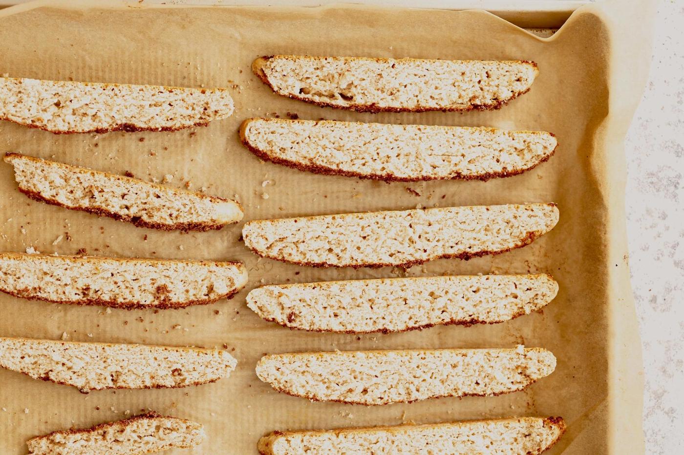 vegan cinnamon sugar biscotti on a parchment paper lined baking sheet