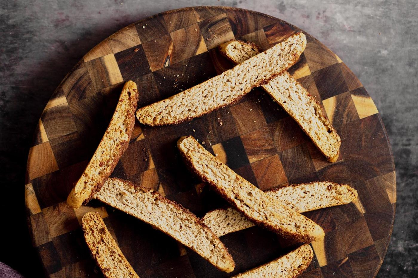 vegan churro biscotti on a wooden plate