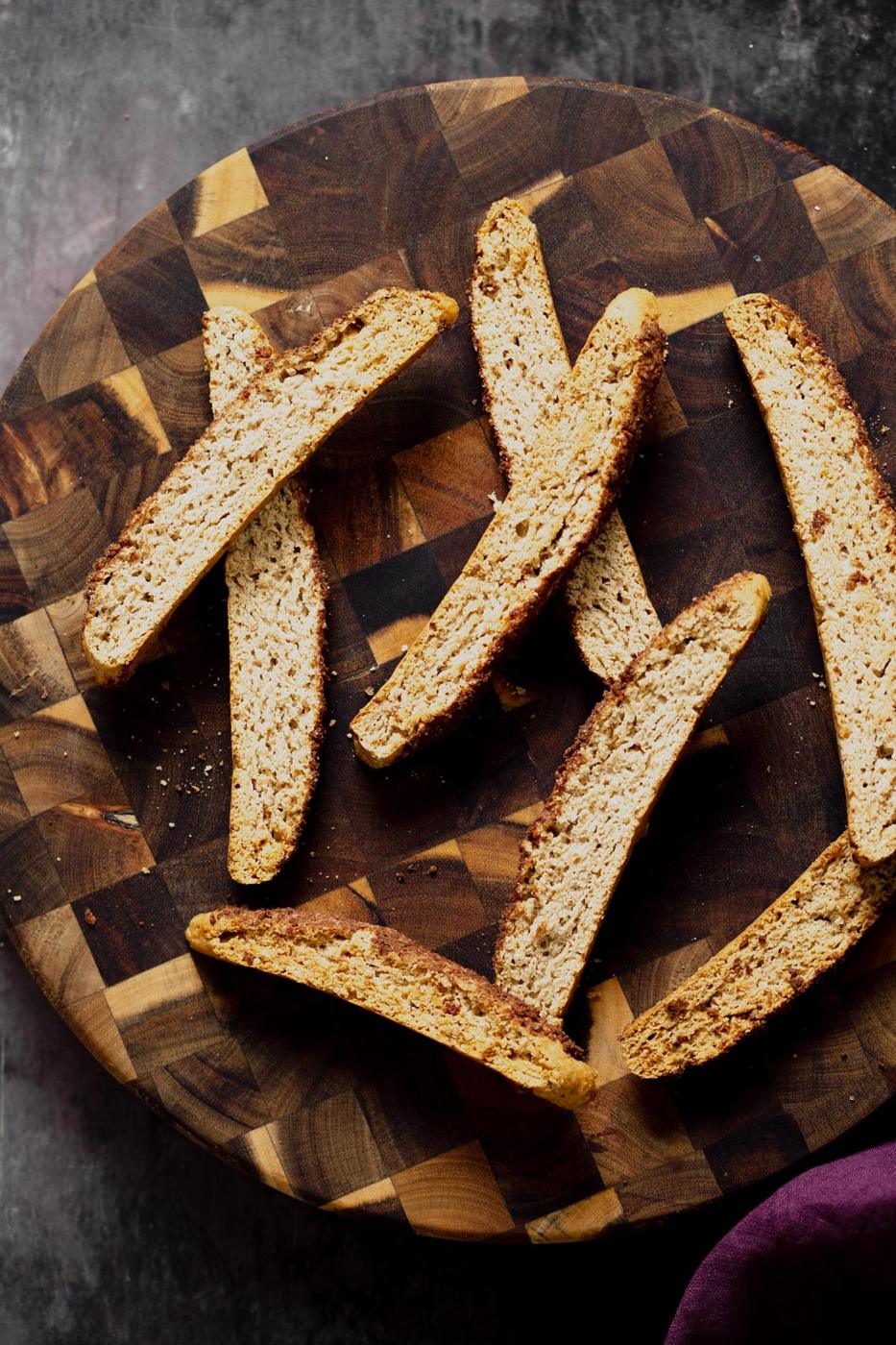 overhead shot of vegan cinnamon sugar biscotti on a wooden plate