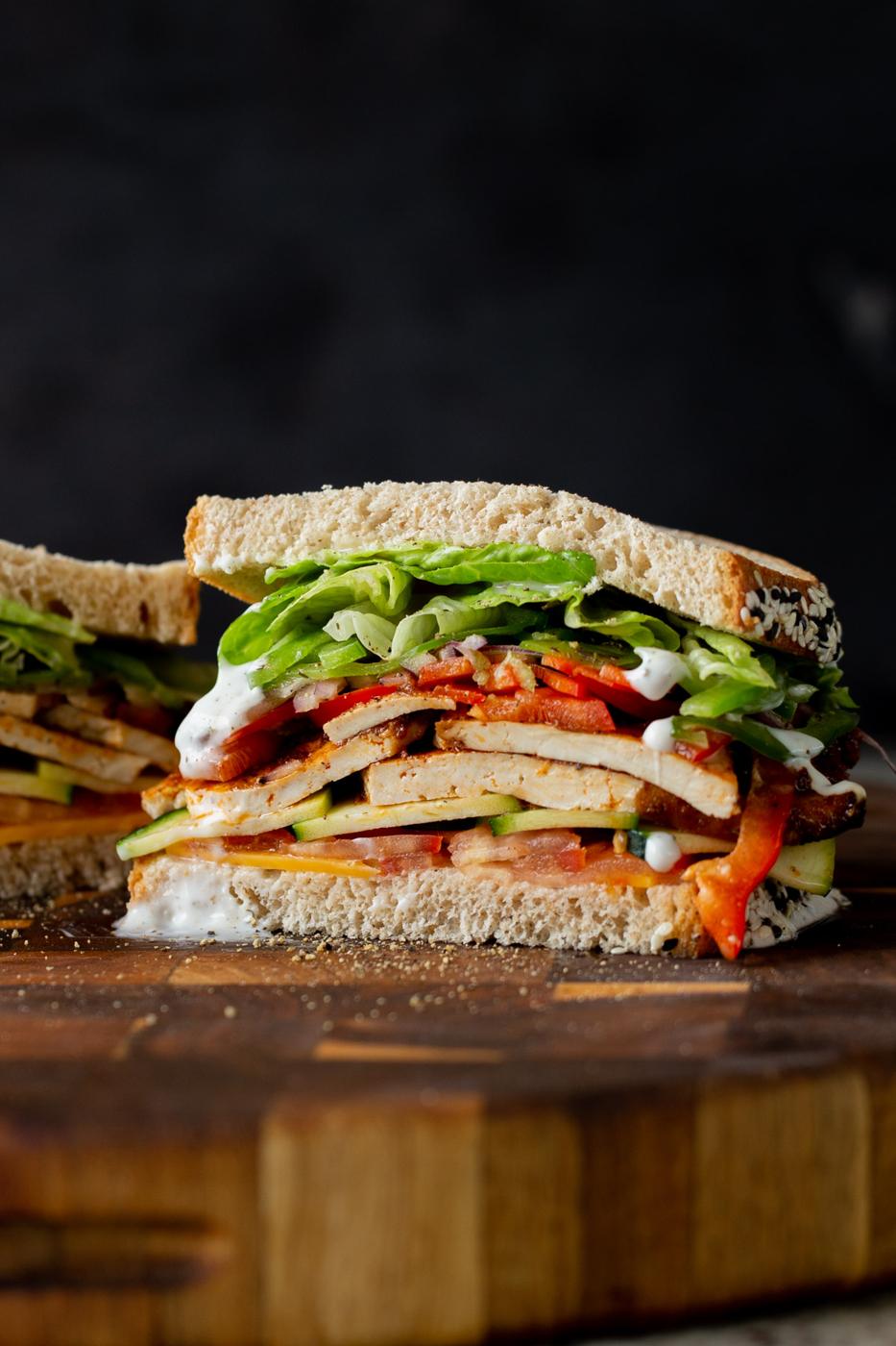 vegan club sandwich sliced in half, so you can see the fillings