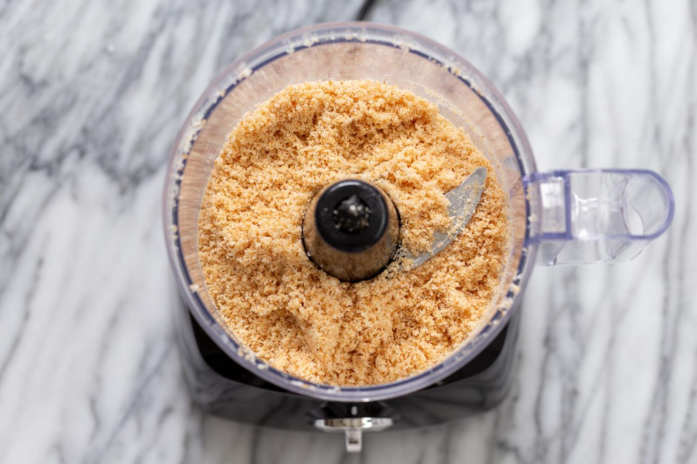 overhead shot of a food processor filled with toasted coconut
