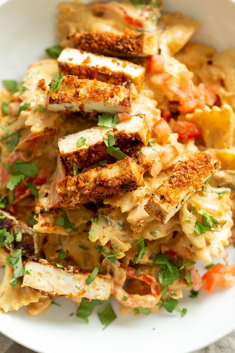 Vegan Creamy Cajun Pasta with Crisp Breaded tofu in a white bowl
