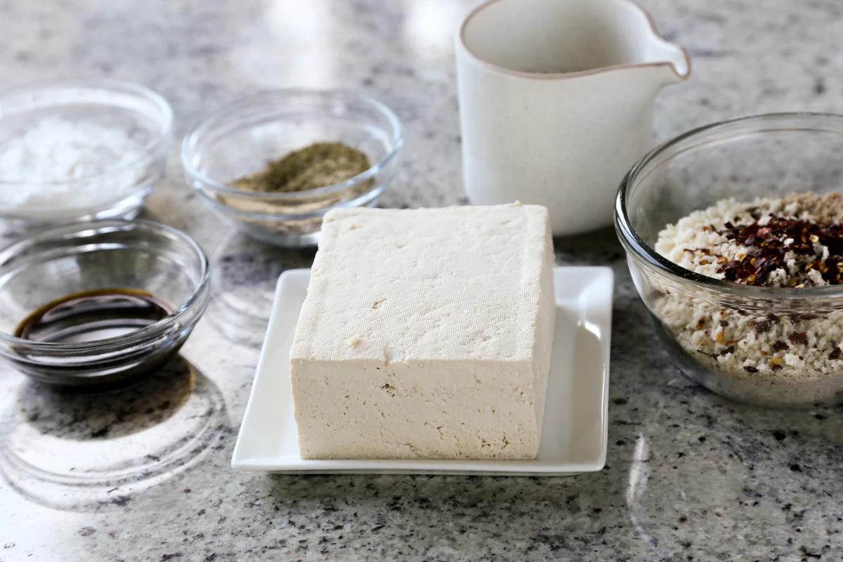 tofu, panko, and other sandwich ingredients in bowls on a kitchen counter