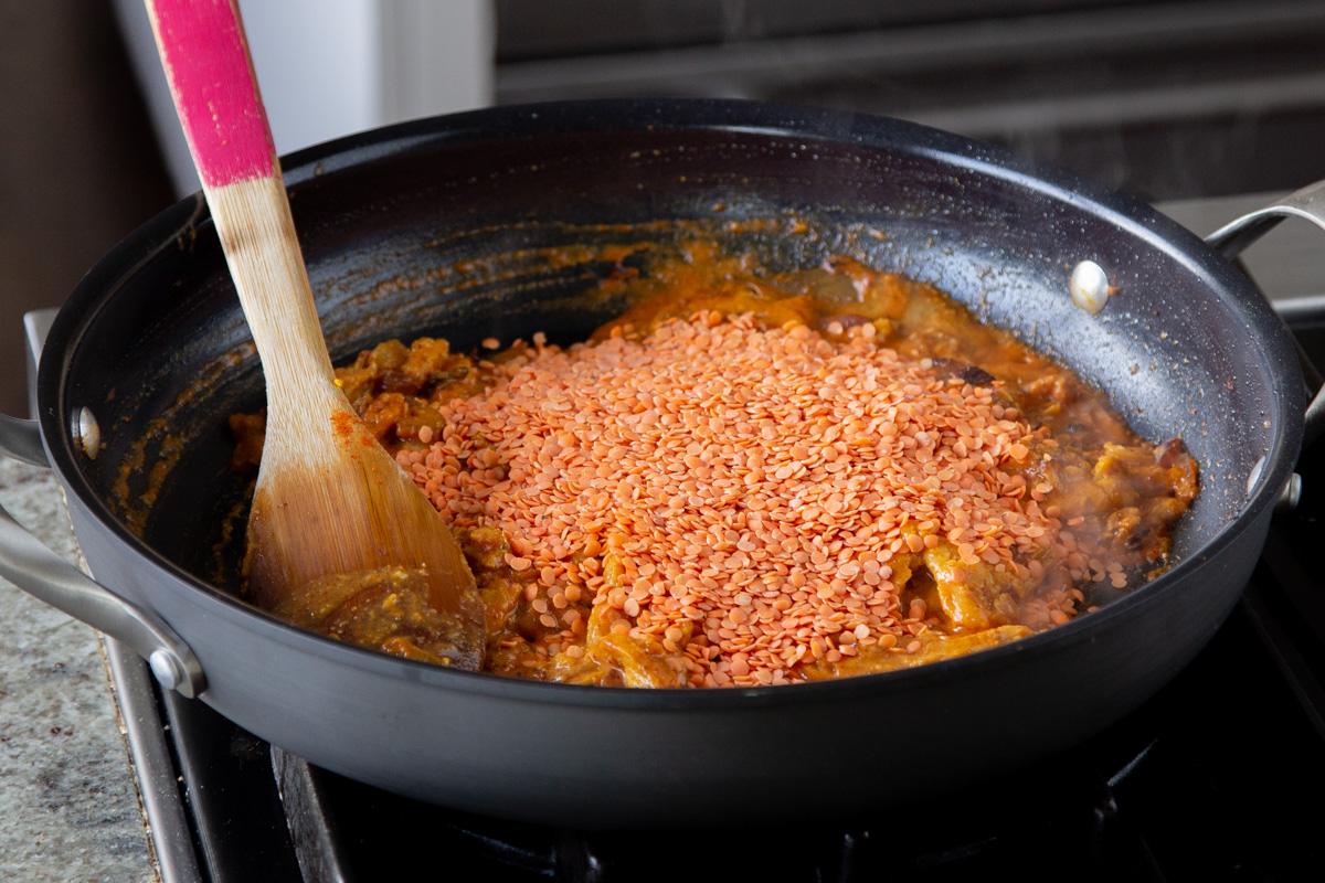 adding dry red lentils to the soy curl mixture