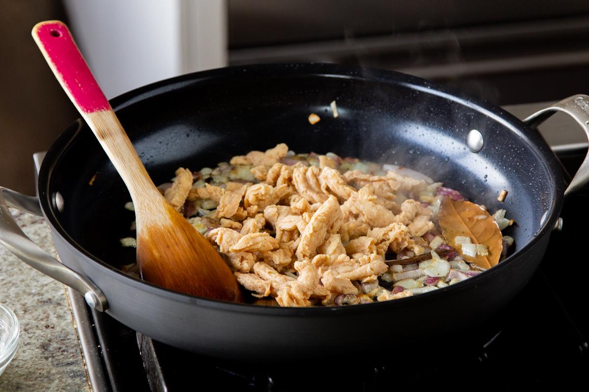 adding soaked and drained soy curls to the pan