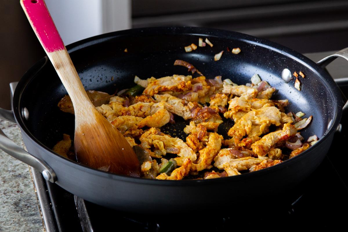 soy curls tossed with the spices in the pan, before cooking