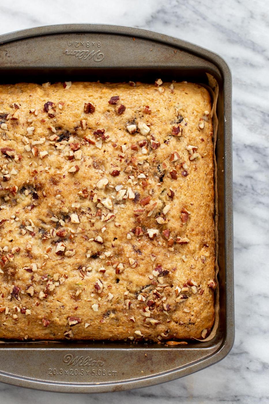 freshly baked vegan date nut cake in a cake pan