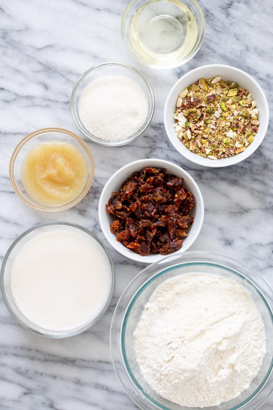 ingredients for vegan date nut cake on a marble countertop