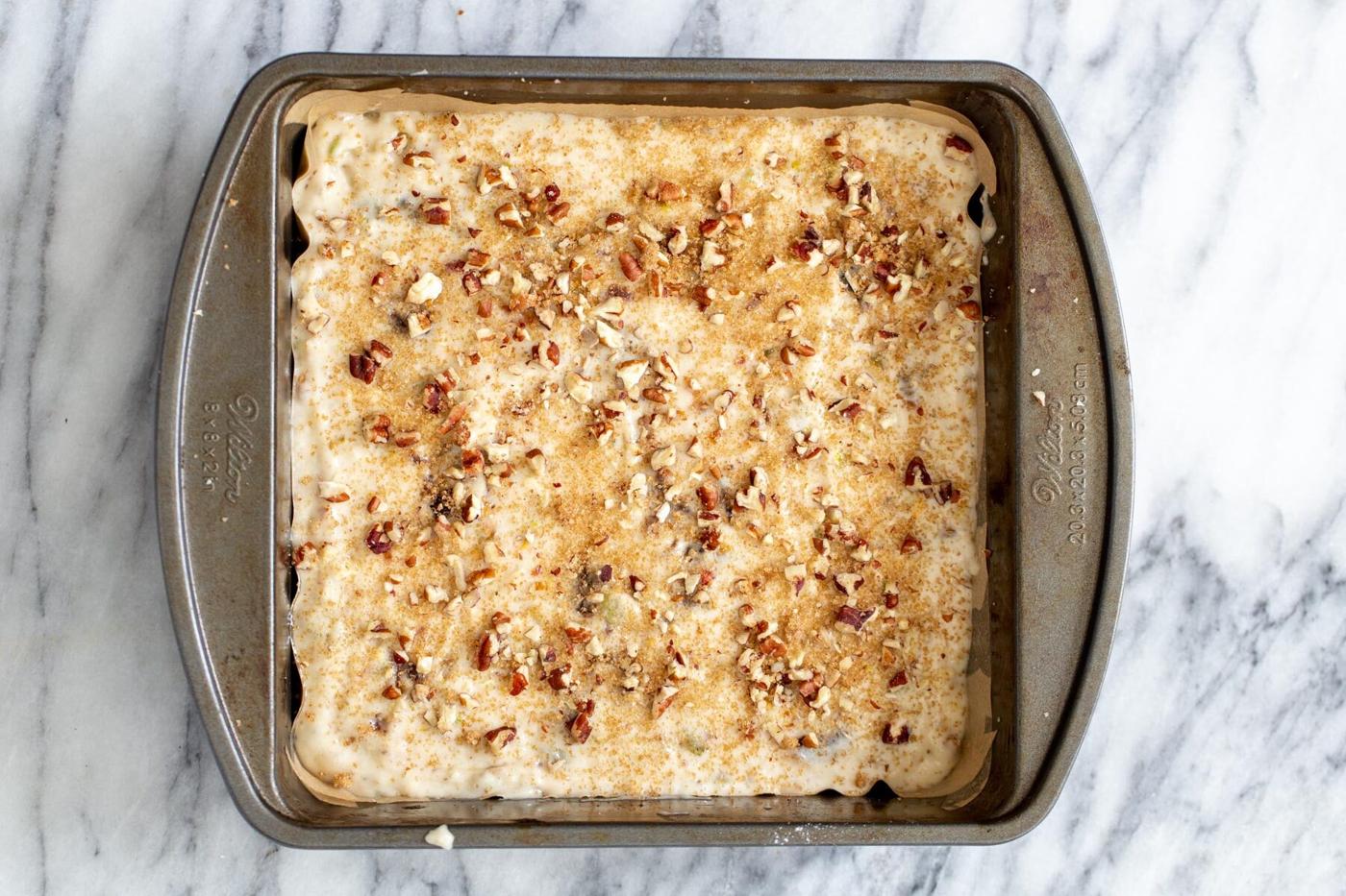 vegan date nut cake batter in a cake pan ready to be baked