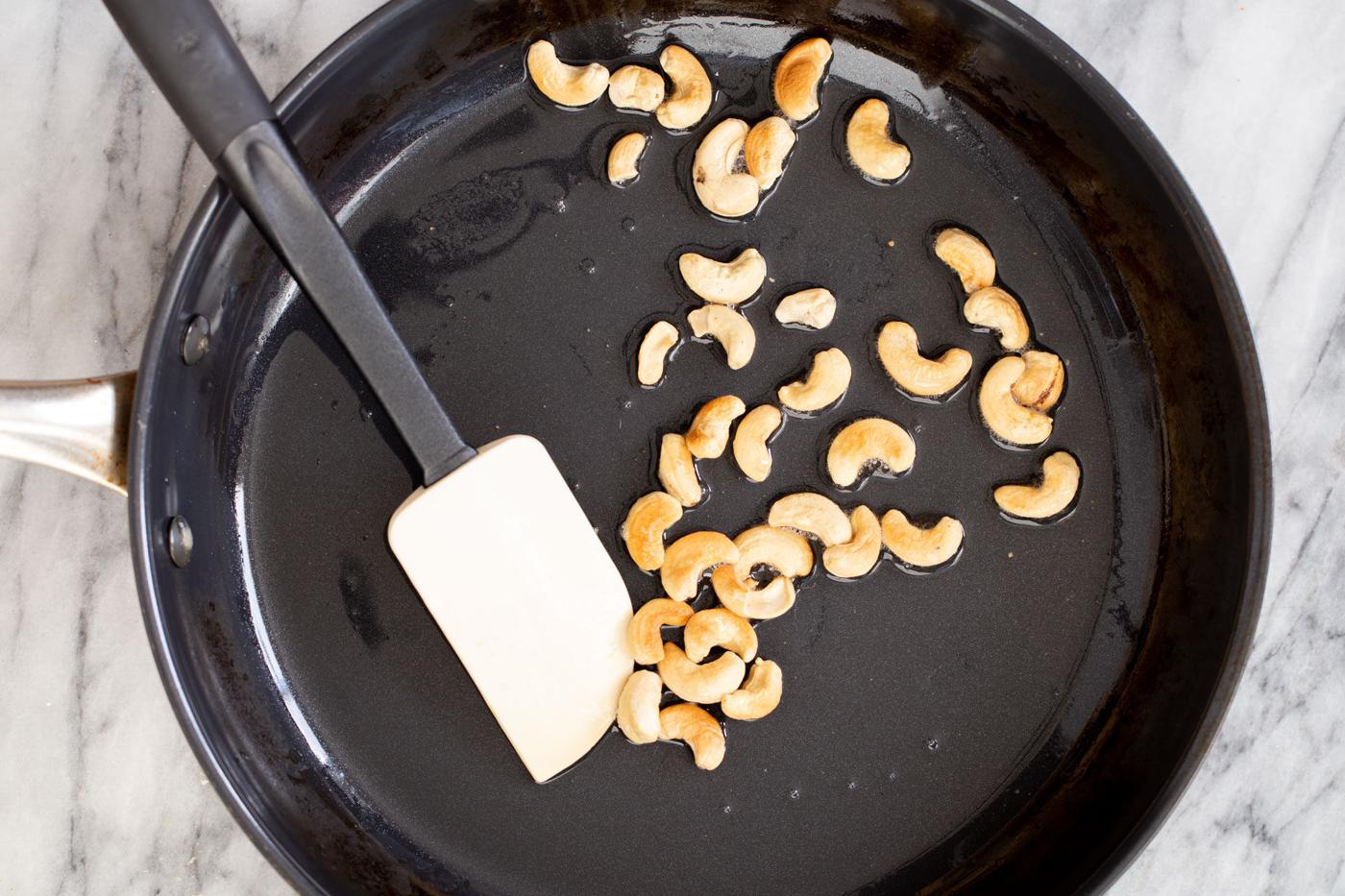 cashew nuts in a sauteeing pan