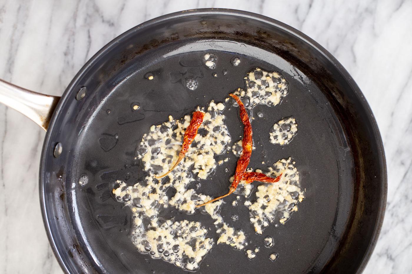 sauteeing pan with minced garlic and chile