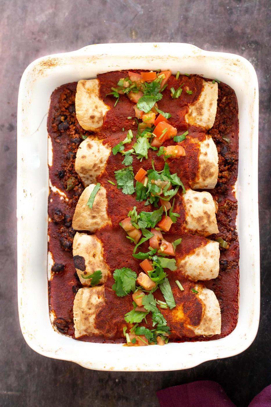 vegan enchiladas filled with cauliflower taco meat and topped with enchilada sauce