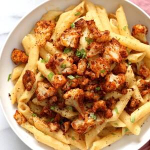 Vegan Garlic Pasta with Roasted Cajun Cauliflower. Cauliflower is tossed in homemade cajun spice blend and baked, then served over easy creamy Garlic sauce Penne Pasta. Vegan Recipe. Can be Nut-free gluten-free | VeganRicha.com
