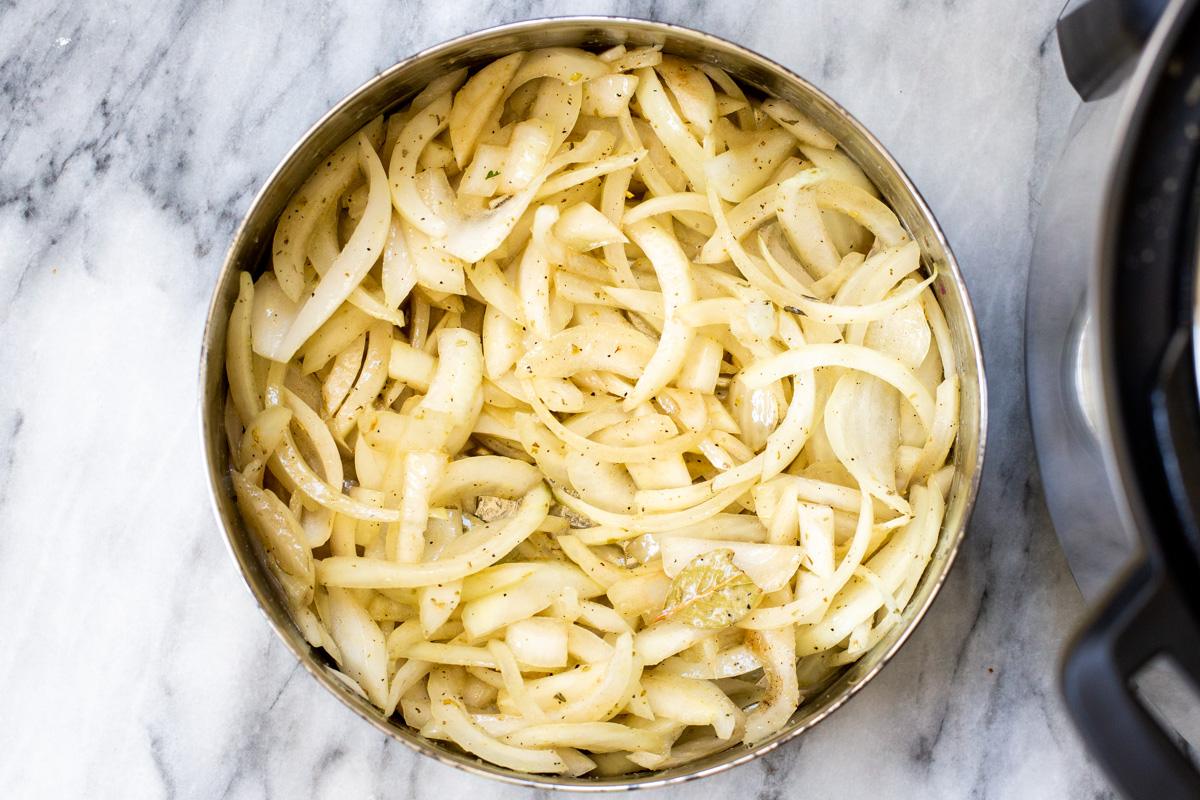 seasoned slices of onion in an Instant Pot