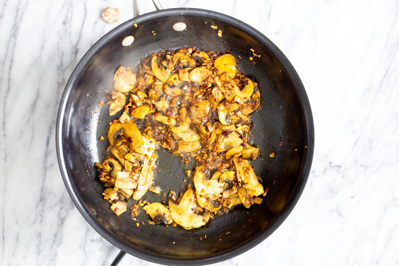 sauteed garlic and mushrooms in a frying pan