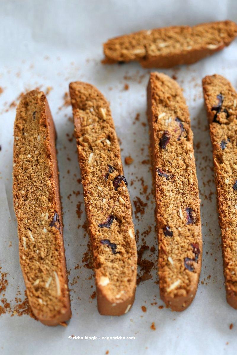 Vegan Gingerbread Biscotti with cranberries, almonds, candied ginger. Easy Crispy Spiced Biscotti Recipe to dunk in a cup of tea. Drizzle with white or dark chocolate. | VeganRicha.com #vegan #gingerbread #biscotti #recipe