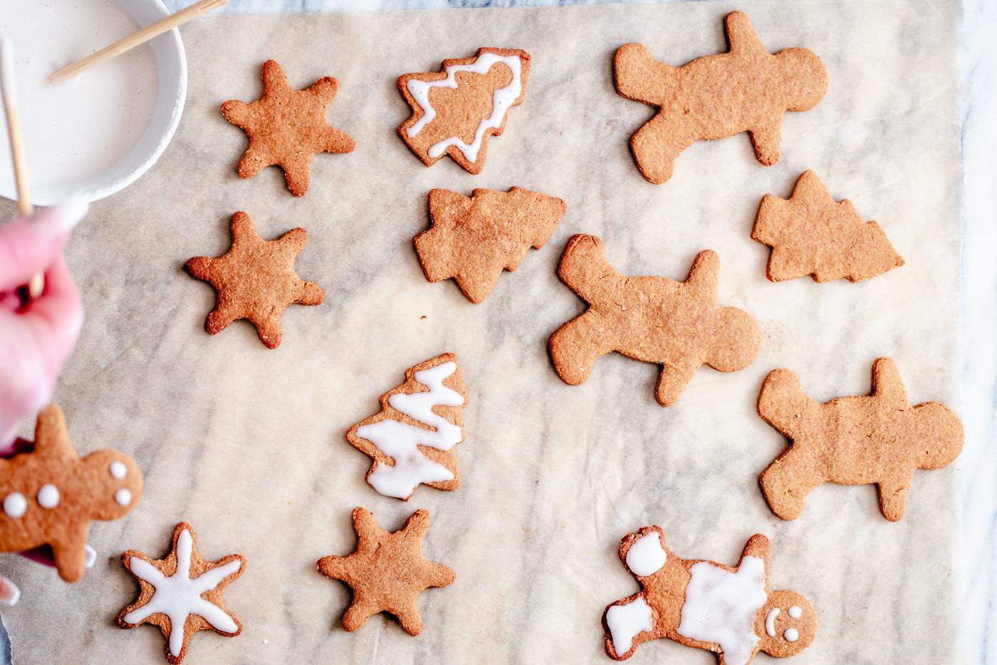 vegan gingerbread cookies being iced