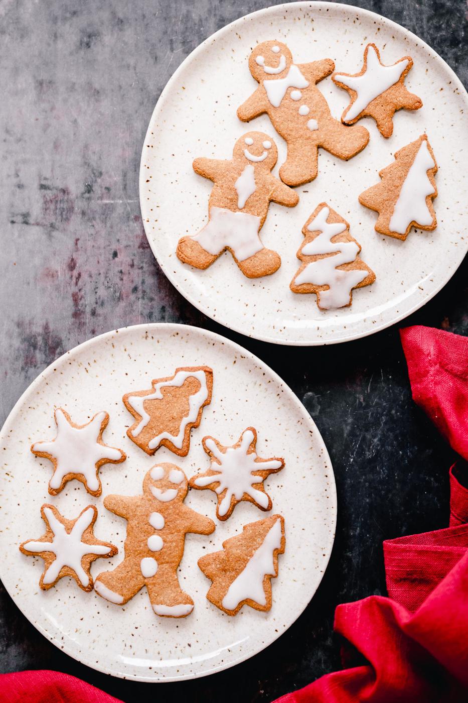 two plates with vegan iced gingerbread cookies