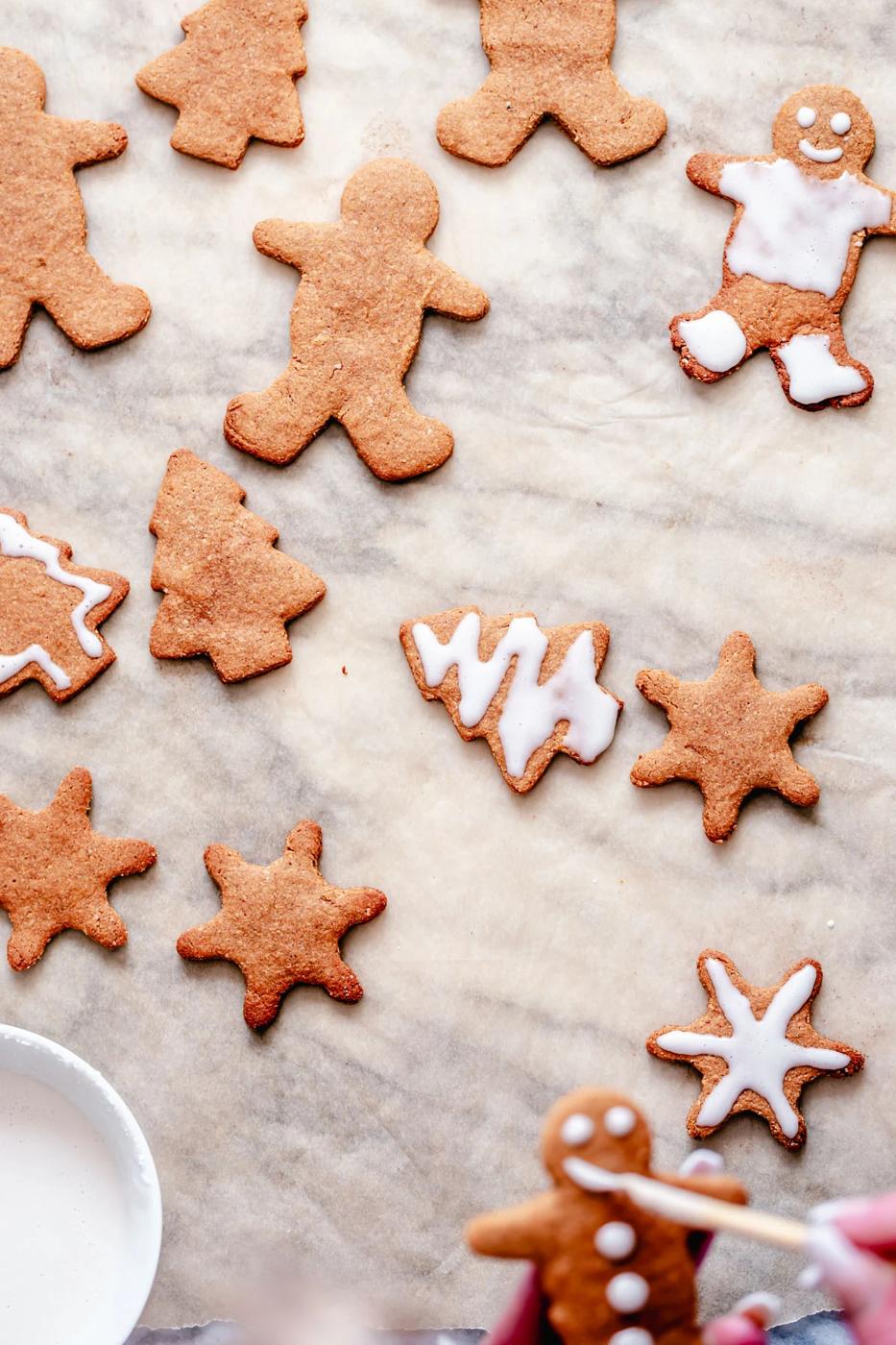 iced vegan spiced gingerbread cookies on a marble countertop
