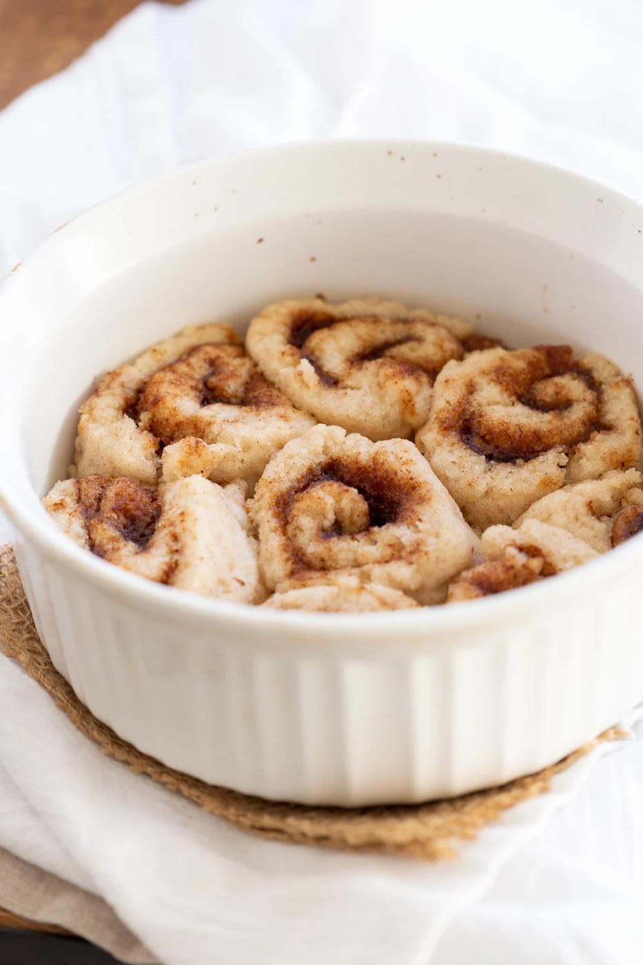 Our Vegan Gluten free Cinnamon rolls in a stoneware dish