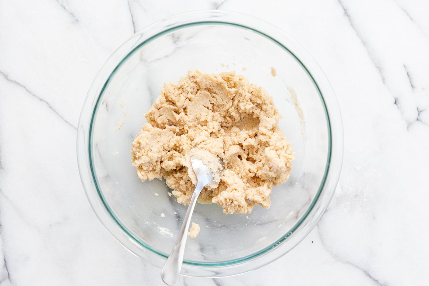 Dough of our Vegan Gluten free Cinnamon Rolls in a glass bowl