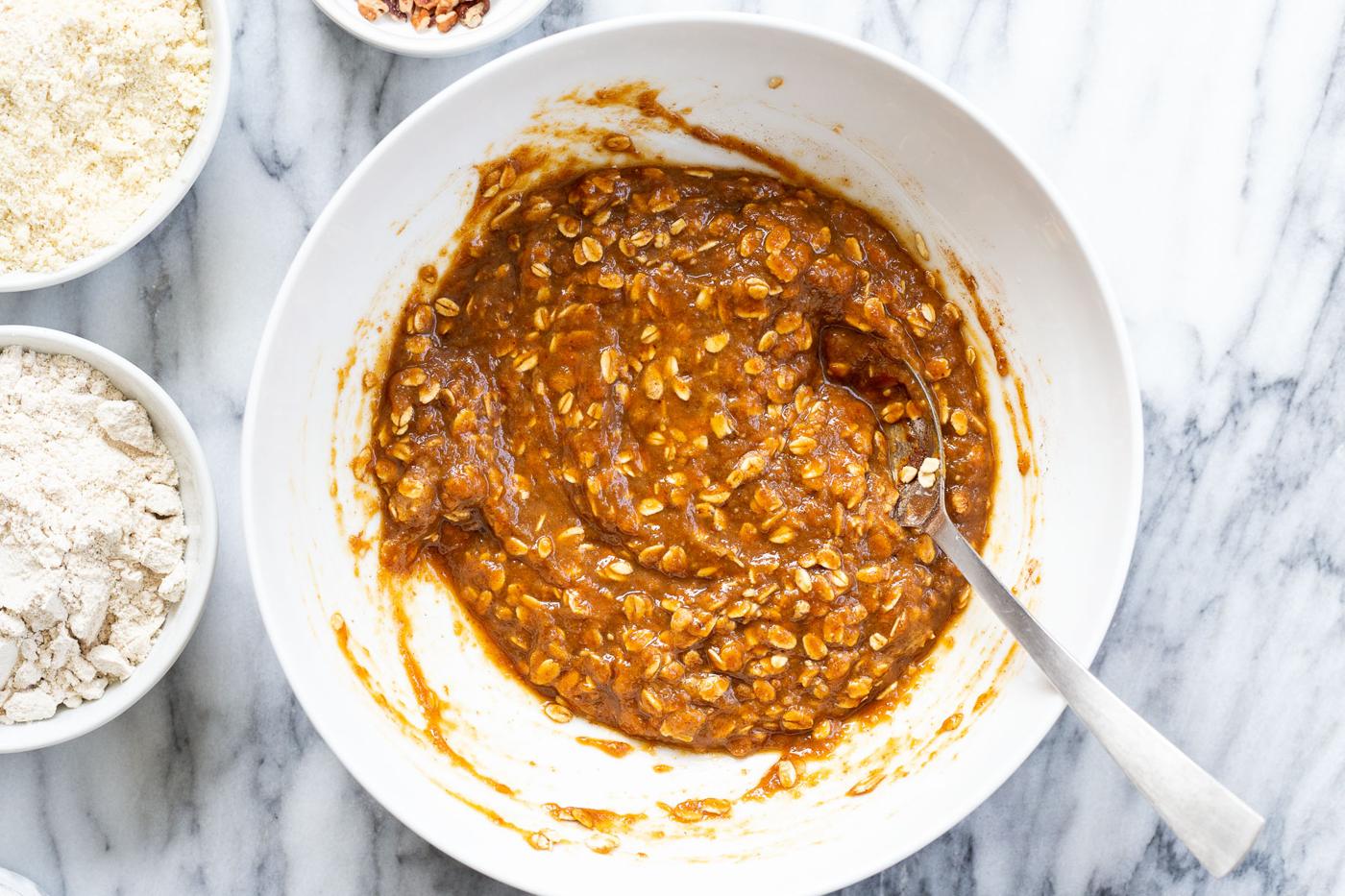 mixed ingredients for pumpkin muffins in white bowl