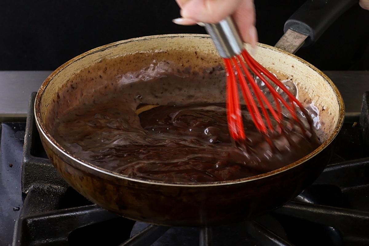chocolate ganache frosting in the pan
