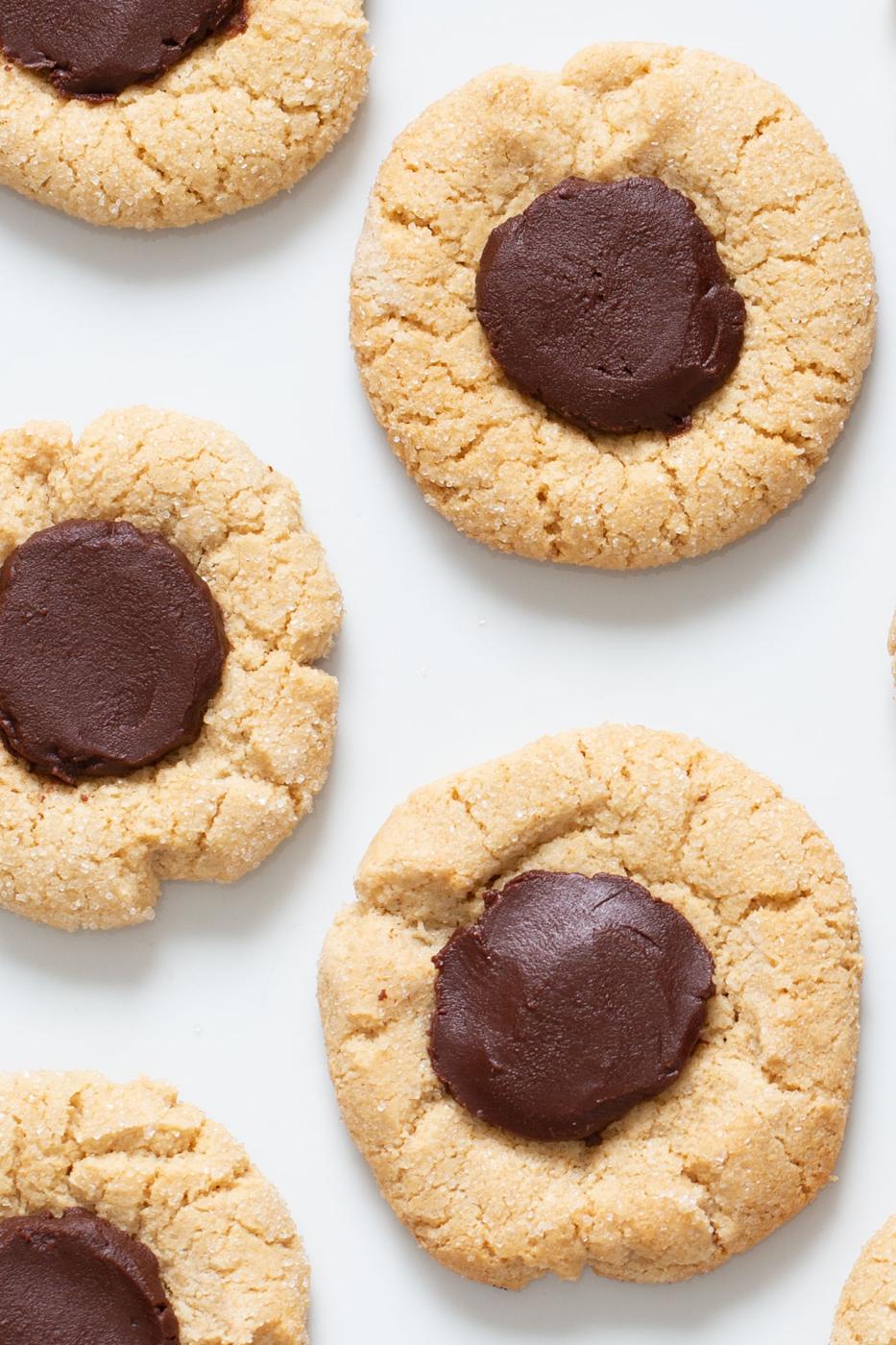 vegan gluten free chocolate thumbprint cookies on a marble counter