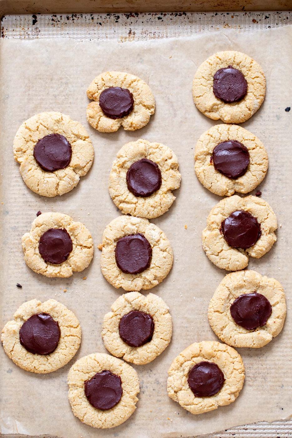 vegan glutennfree chocolate thumbprint cookies on a baking sheet