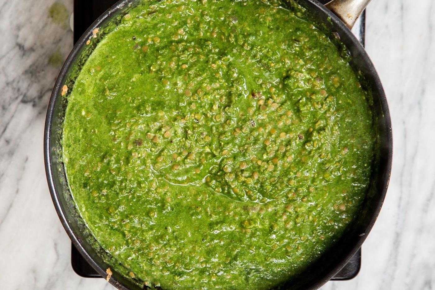lentils and green herb sauce in a black skillet
