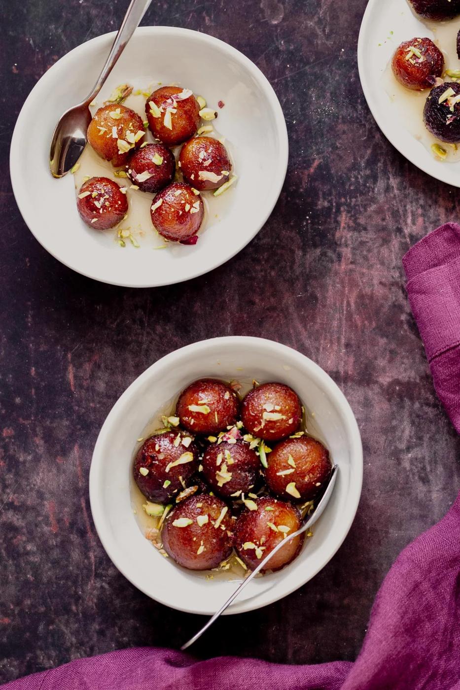 overhead shot of two servings of vegan gulab jamun donuts made from a homemade dry mix