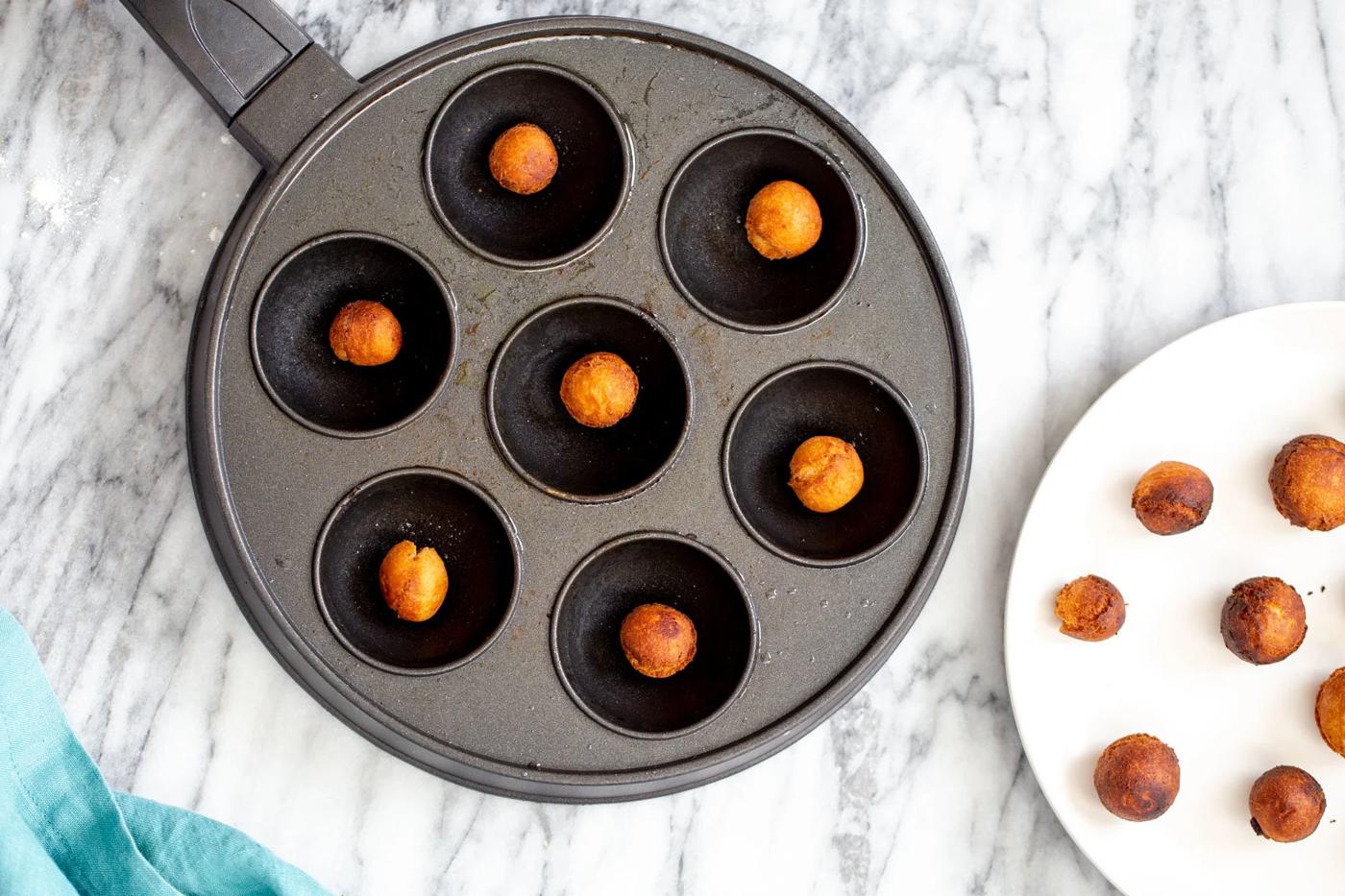 an aebleskiver pan with homemade vegan gulab jamun