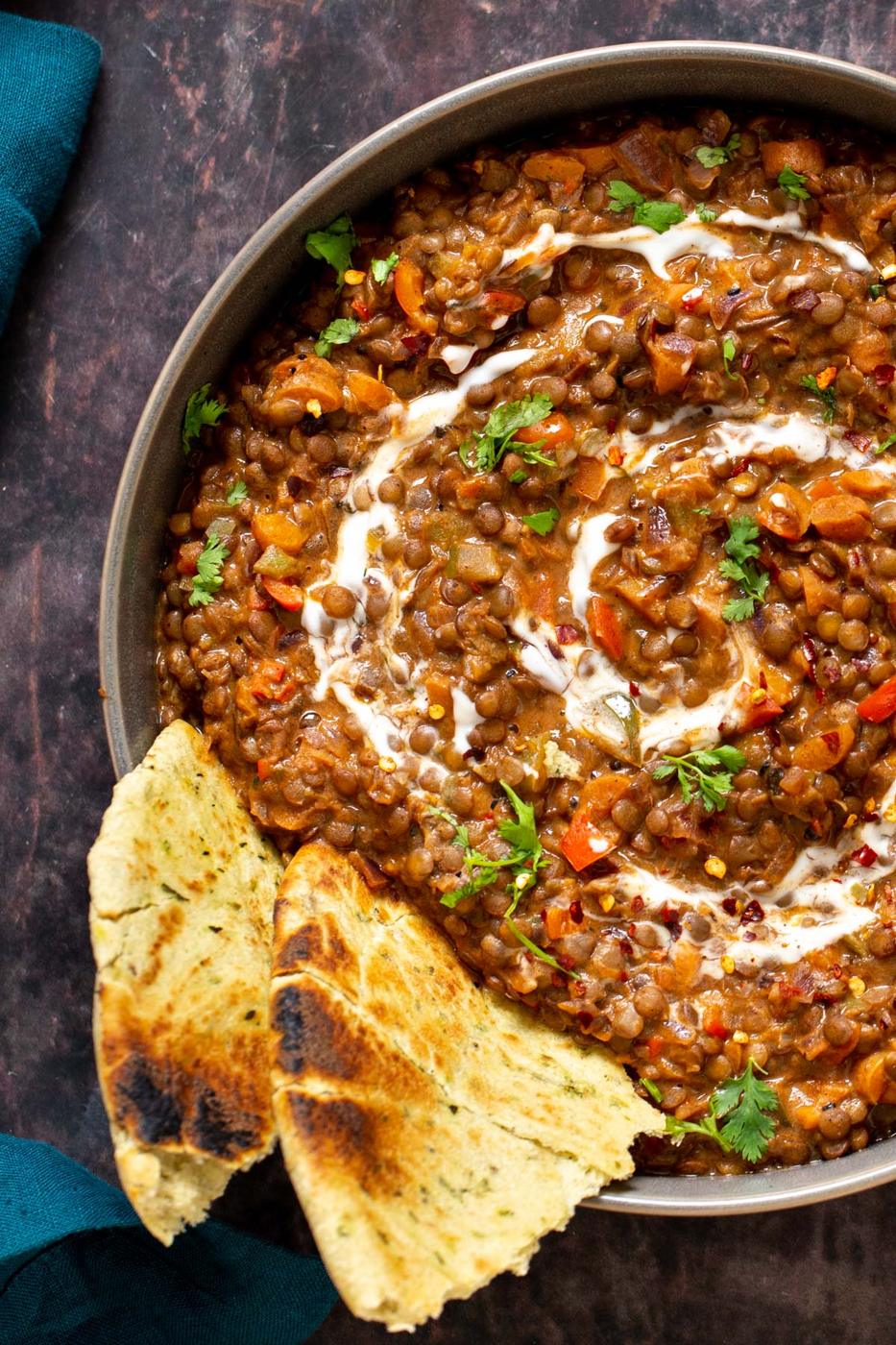 vegan handi lentils curry served with naan bread