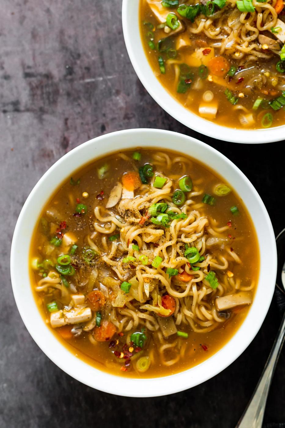 overhead shot of two bowl of Chinese Hot and Sour Soup with Ramen noodles served in two soup bowls
