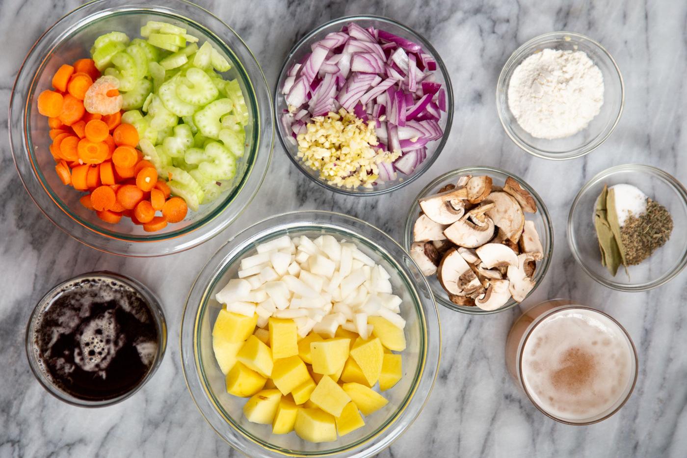ingredients for making vegan Irish stew on a marble countertop