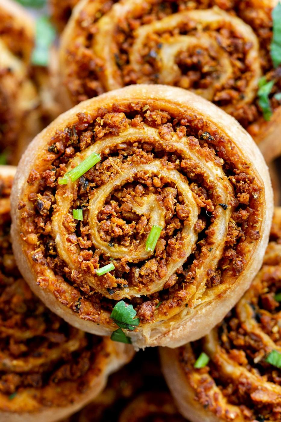 close up of a platter of puff pastry pinwheels with lentil filling