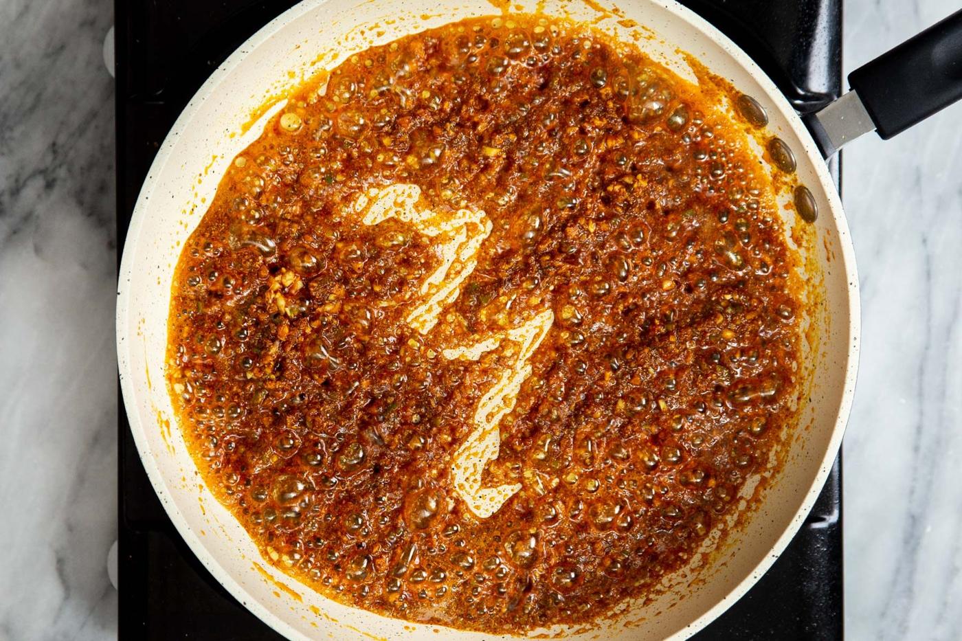 Indian spice paste frying in a sauteeing pan