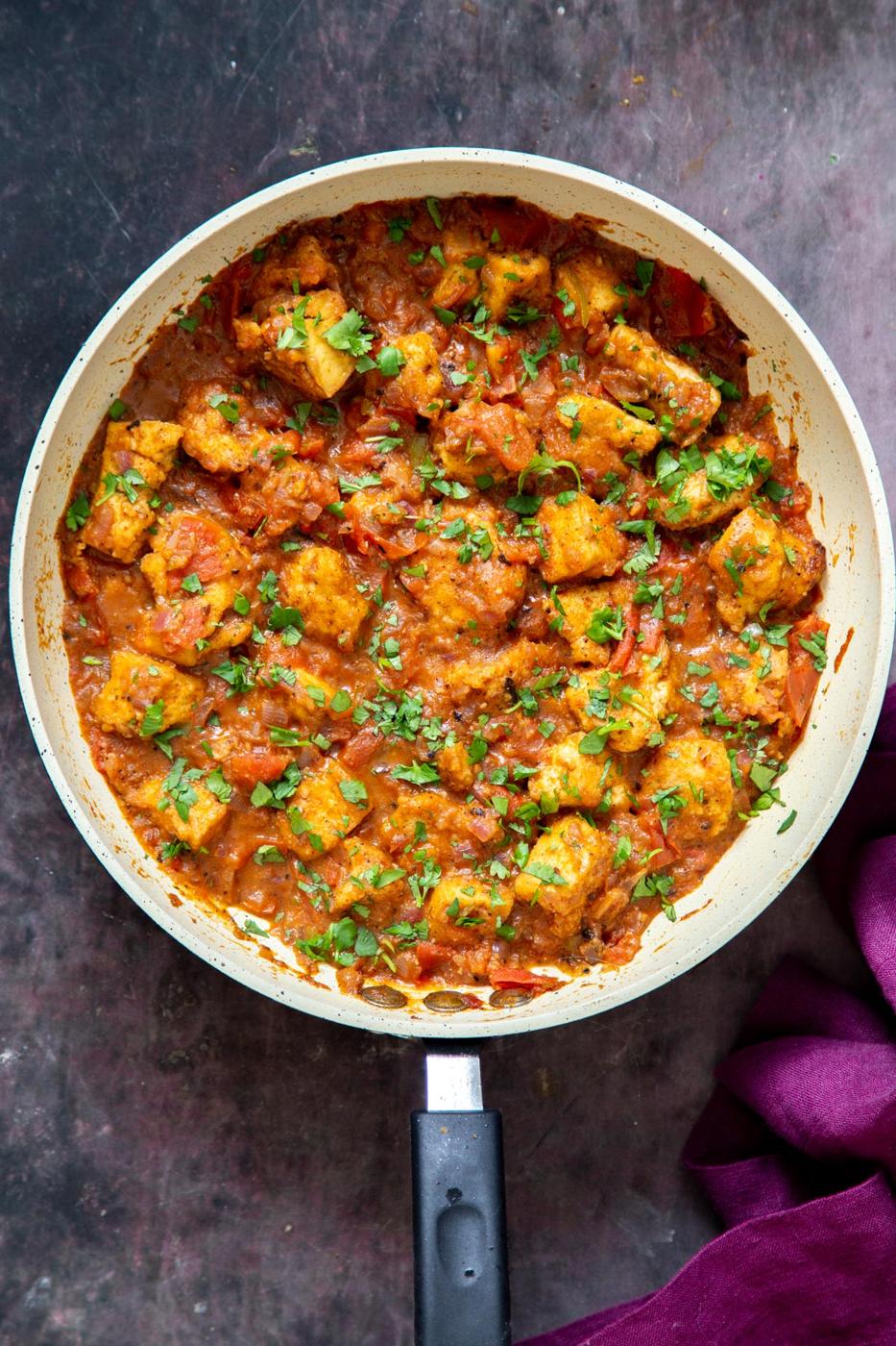 overhead shot of a sauteeing pan with Khada Masala Murg Curry with Baked Tofu sprinkled with cilantro
