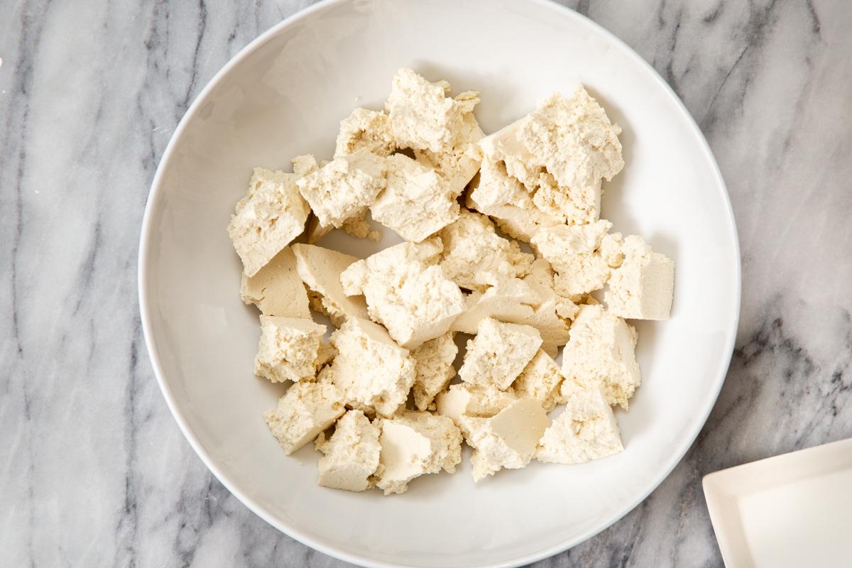 pieces on torn-up firm tofu in a white bowl
