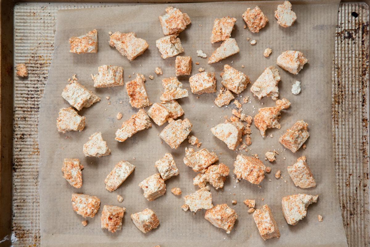 torn up seasoned tofu chunks on a baking sheet