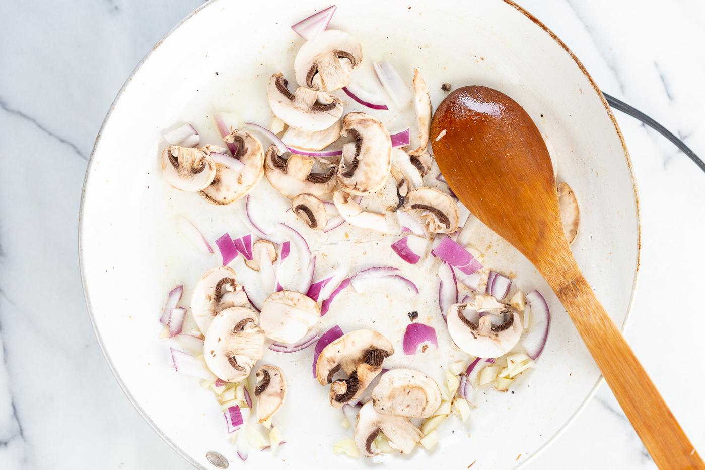 Onion and mushroom in a skillet for our Vegan Lemon Asparagus Pasta