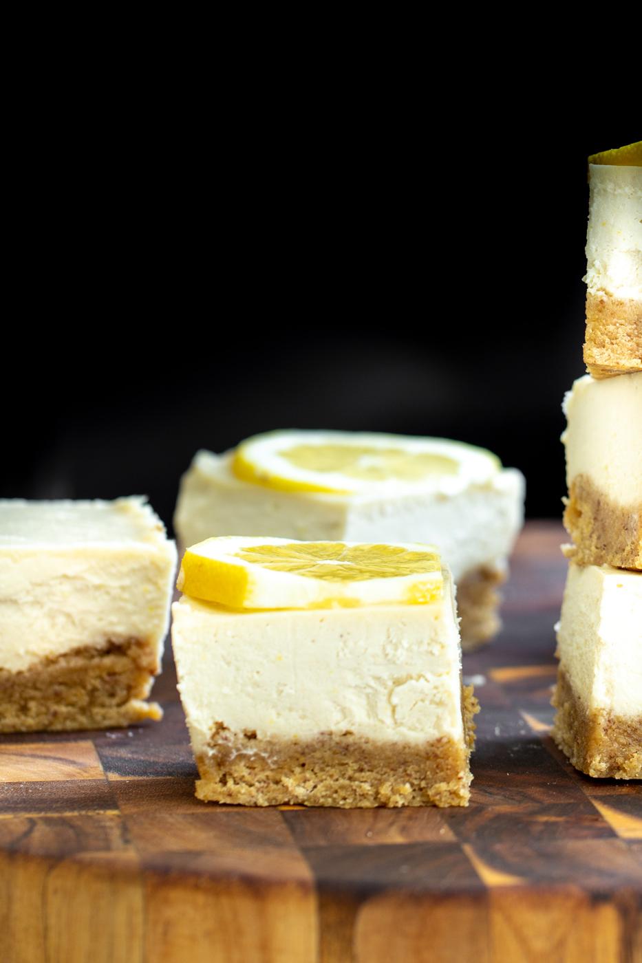 vegan lemon bars with glutenfree crust on a wooden chopping board