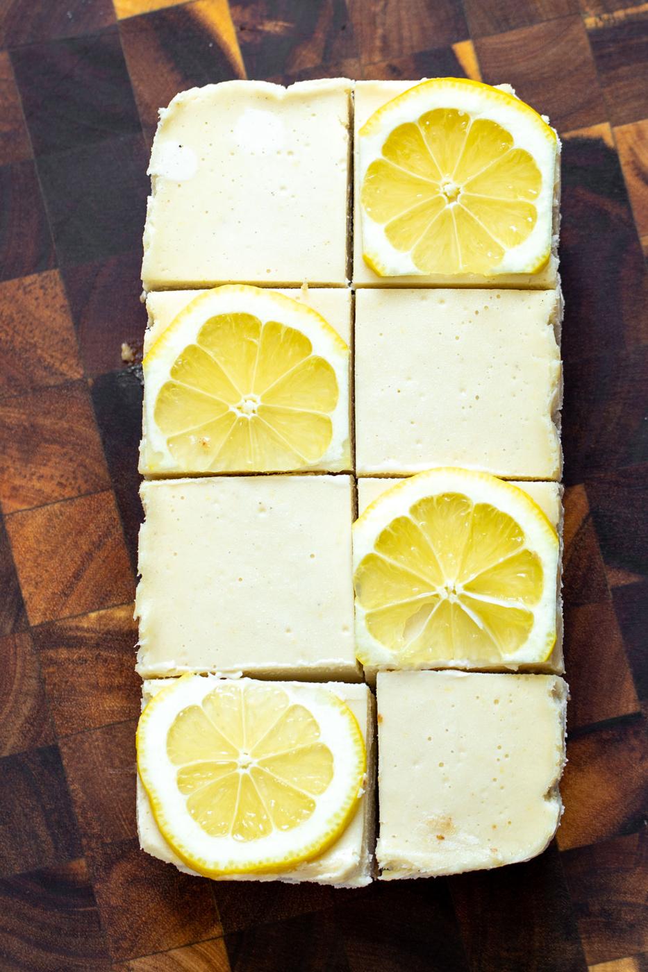 vegan lemon bars topped with fresh lemon slices